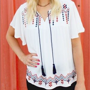 White top with red and navy embroidery